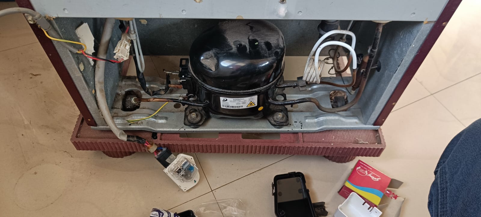 Technician Repairing Fridge